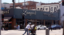 LOS ANGELES, CA - AUGUST 21, 2024 - A man walks with his belongings in a shopping cart across the street from Langer&apos;s Deli, also known as Langer&apos;s Delicatessen-Restaurant, in in the Westlake neighborhood of Los Angeles, opposite MacArthur Park, on August 21, 2024. Norm Langer, 79, president and chief executive of Langer&apos;s Delicatessen-Restaurant, is thinking of closing the deli after 77 years in business, due to neighborhood challenges. 