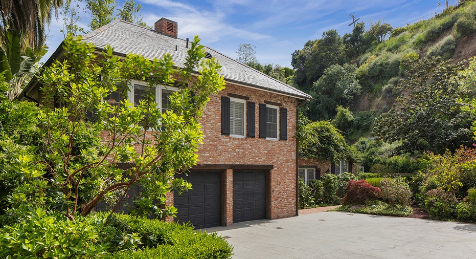 Brick home with 3 garage doors