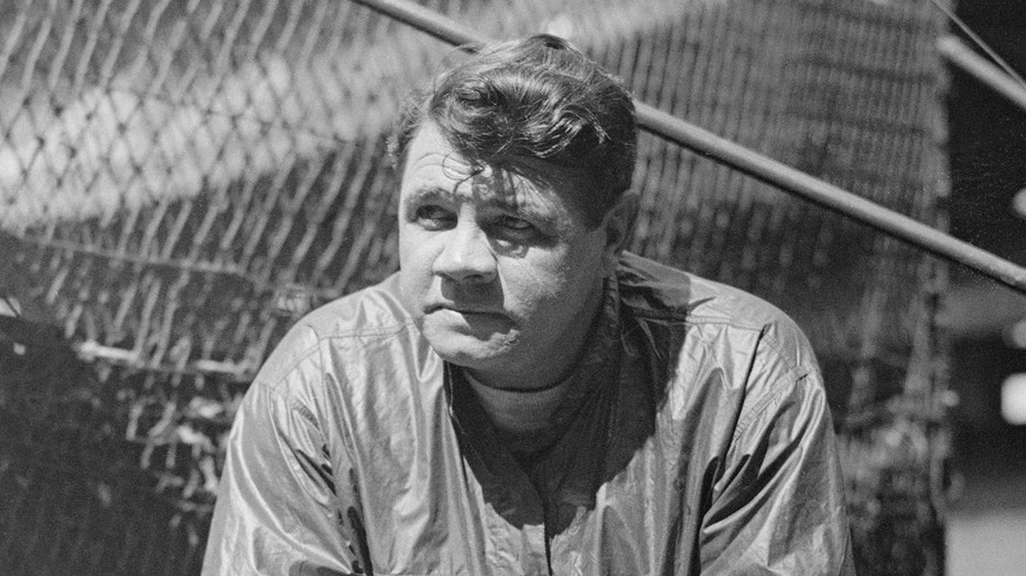 Babe Ruth looks on field