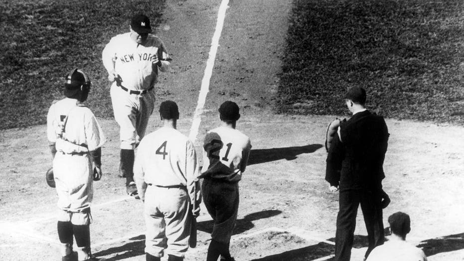 Babe Ruth touches home plate