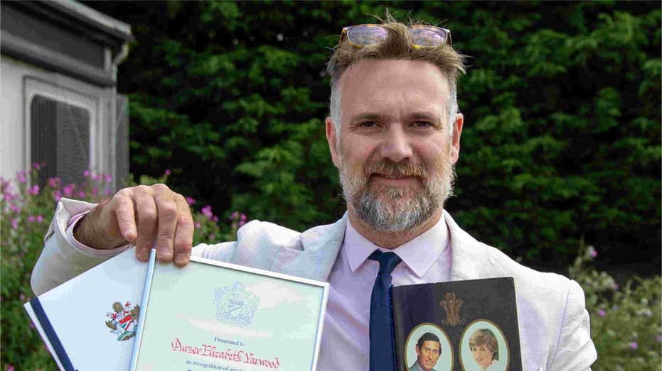 Charles Hanson holding British Airways and Concorde memorabilia