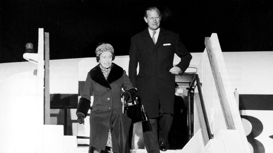 Queen Elizabeth disembarks from a plane in 1977.