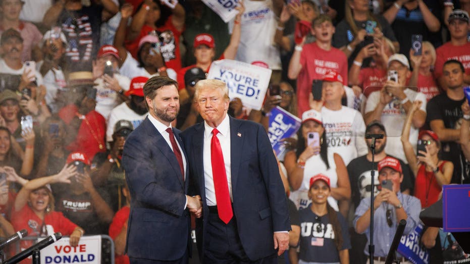 Former President Trump and JD Vance shake hands