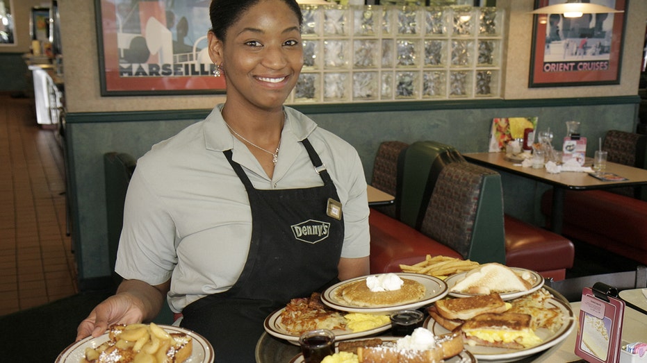 A waitress serving food at Denny's Restaurant.