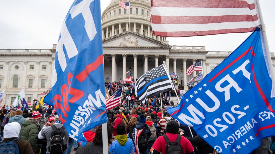 Trump flags fly as rioters storm the steps of the Capitol on the East Front, Wednesday, Jan. 6, 2021, as Congress works to certify the Electoral College votes.