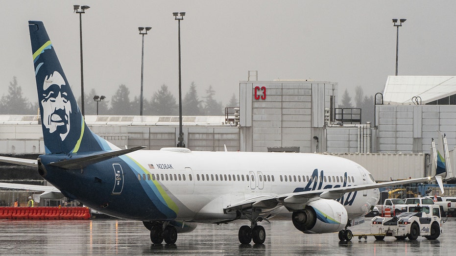 An Alaska Airlines Boeing 737-900ER is on the tarmac at SeaTac