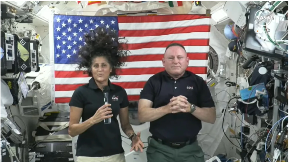 NASA astronauts Suni Williams and Butch Wilmore swim inside the spacecraft