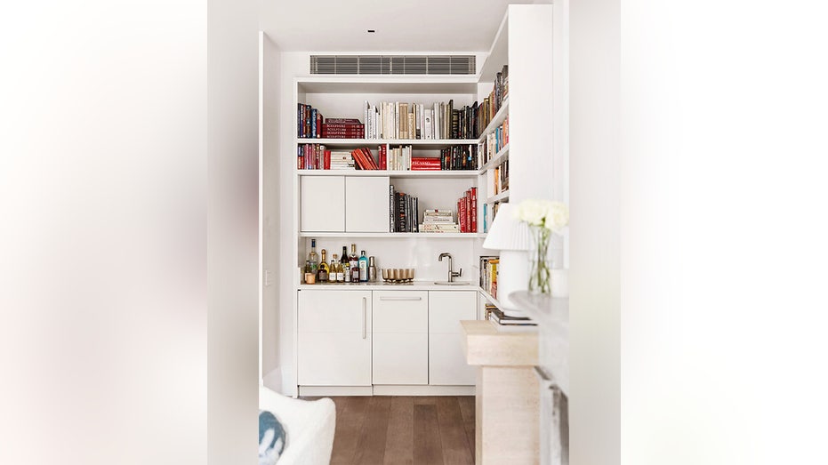 A wet bar with a hidden refrigerator and dishwasher