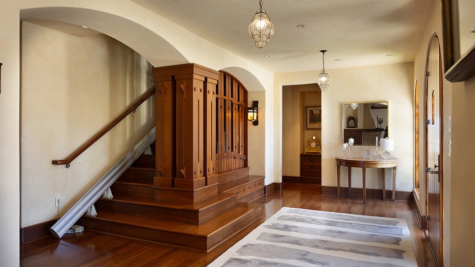 Upon entering, guests are greeted by a wooden staircase and individual decorations.