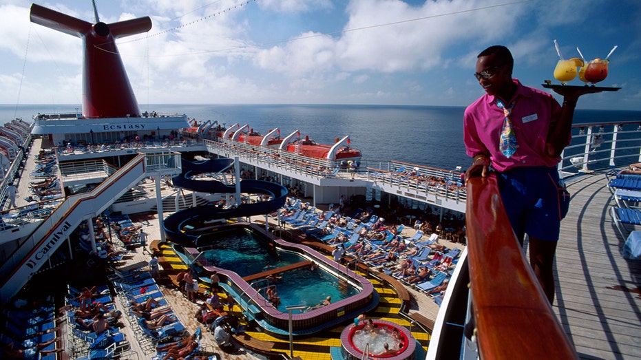 Carnival Ecstasy cruise ship, bartender with drinks on Lido Deck