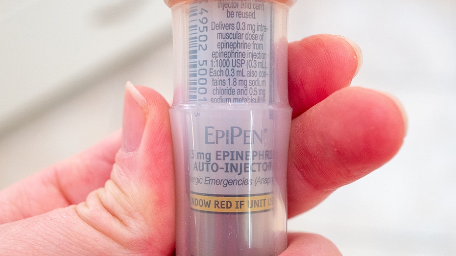 EpiPen being held in someone's hand