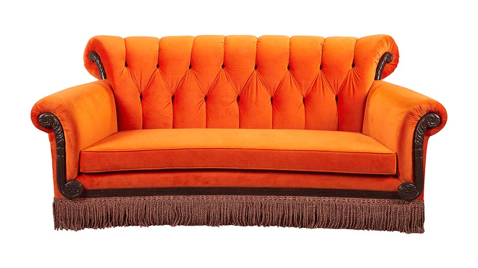 A photo of a replica of the orange couch from "Friends."