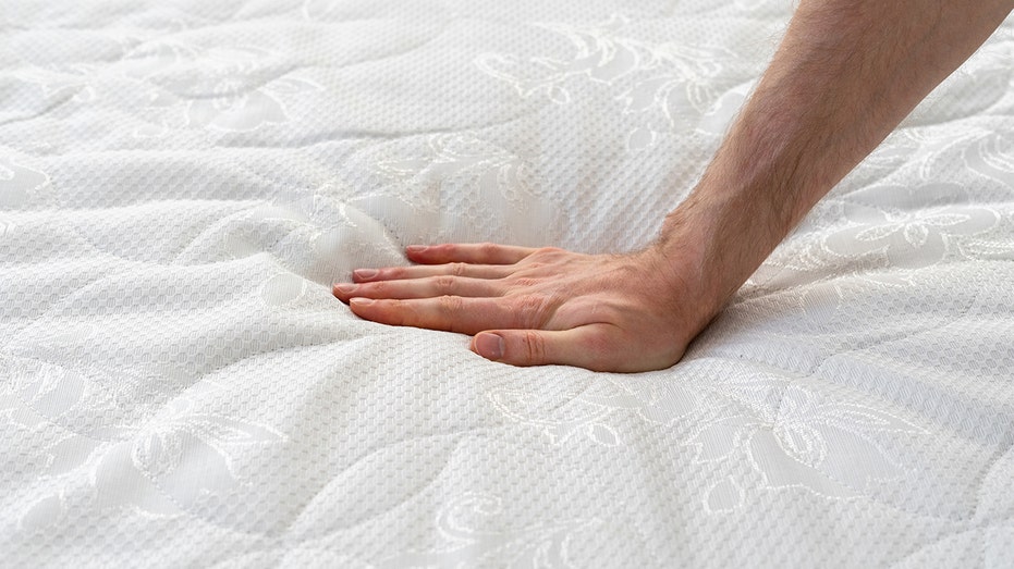 hand on matress iStock