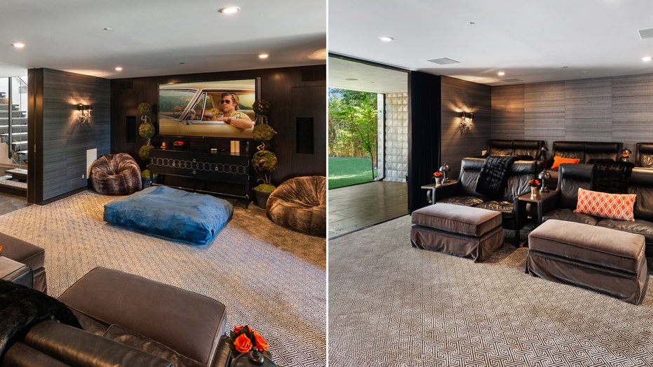 The home features a home theater which boasts a large screen, layered seating and opens up to a large grass field.