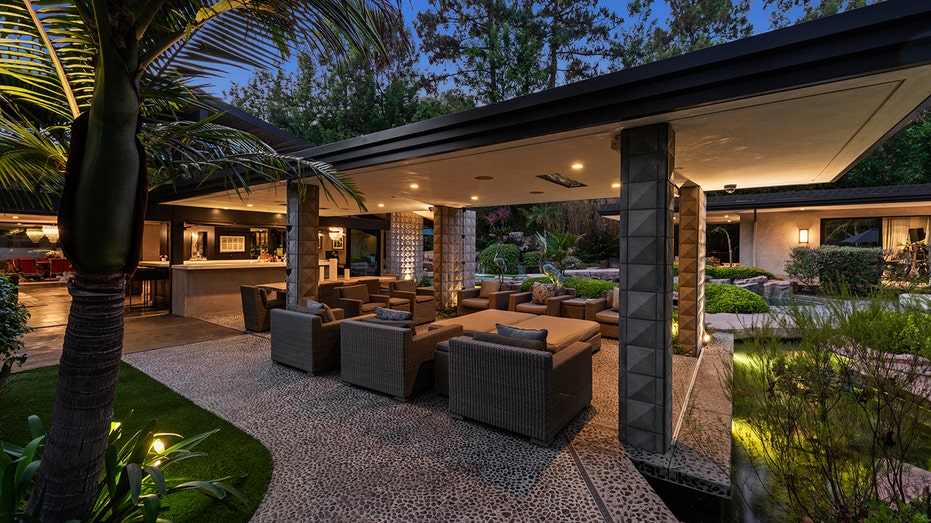 The covered terrace offers plenty of space for guests and an outdoor dining area.