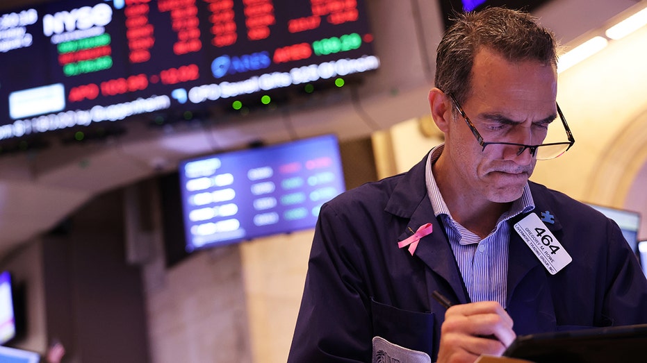 Traders work at the New York Stock Exchange