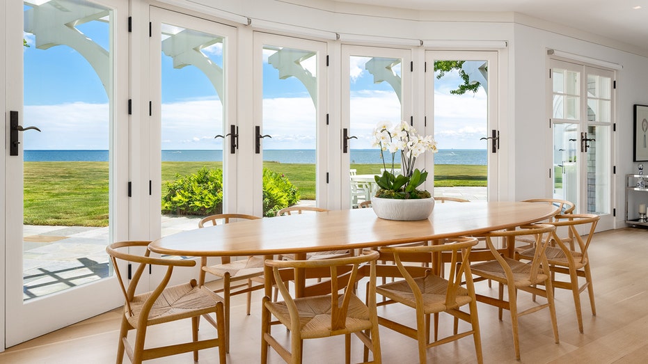 The dining room is surrounded by French doors on one side and has enough room for a table fit for 10.