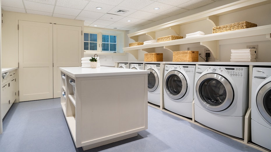 The home boasts a large laundry room with multiple machines.