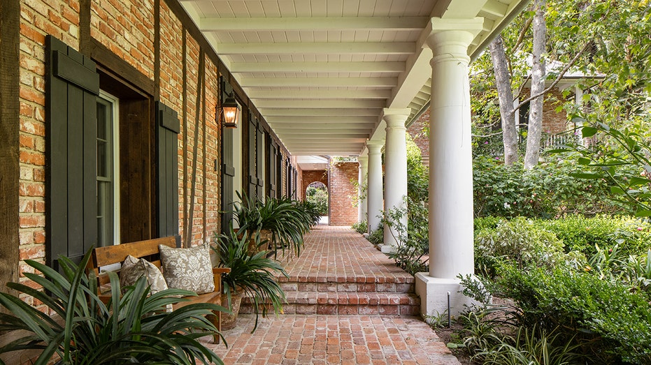 Look at the walkway of the house with brick floors