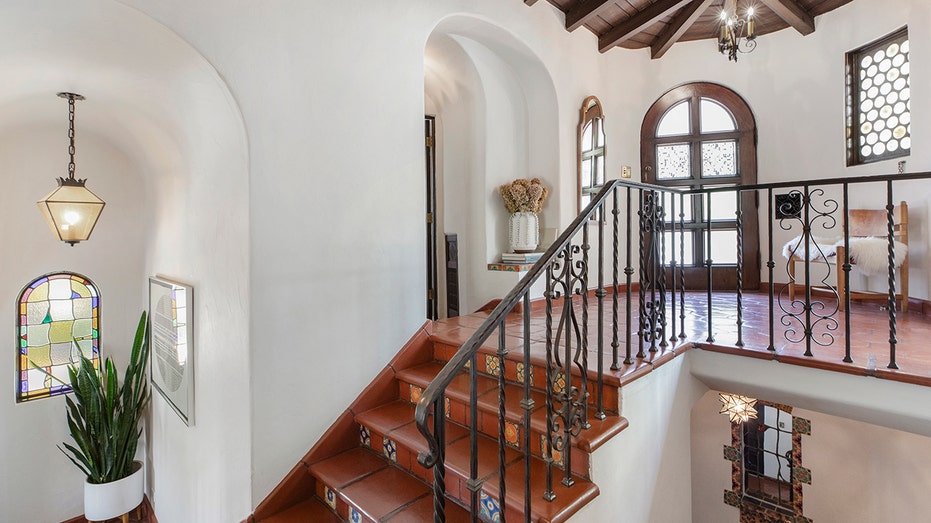 The home's entry features two staircases going in different directions.