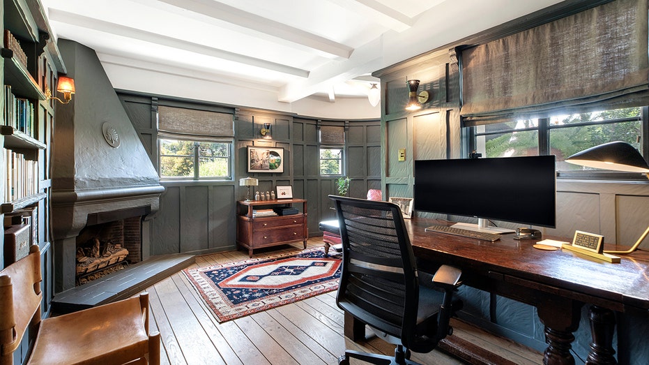 The home features a designated office space with a monogrammed fireplace.