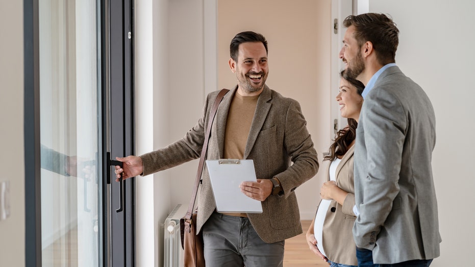 Real estate agent showing couple home