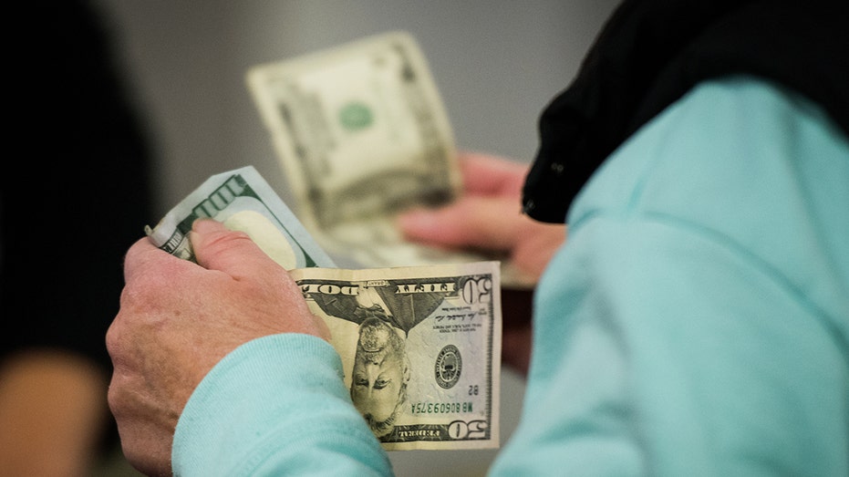 Paramus, NJ shopper paying with cash