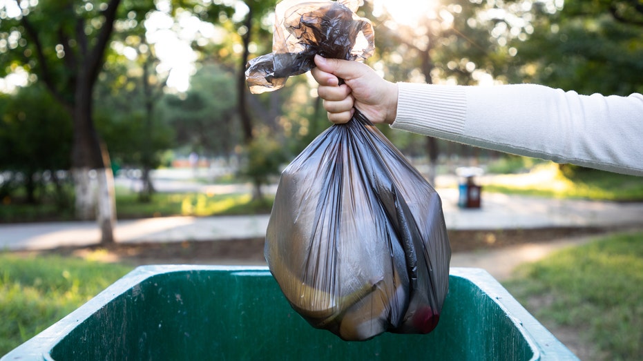 A person throwing away their trash