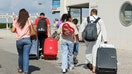 People walk with their luggage outside Beirut Rafic Hariri International Airport on Thursday, Sept. 19.