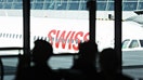 Branding sits on the fuselage of a passenger aircraft, operated by Swiss International Air Lines AG, at Zurich Airport, operated by Flughafen Zuerich AG, in Zurich, Switzerland, on Wednesday, July 6, 2016.