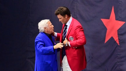 Team owner Robert Kraft presents Tom Brady with his red jacket during the New England Patriots Hall of Fame induction Ceremony for Tom Brady at Gillette Stadium.