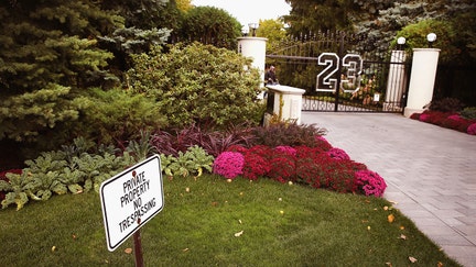 HIGHLAND PARK, IL - OCTOBER 21: A gate with the number 23 controls access to the home of basketball legend Michael Jordan on October 21, 2013 in Highland Park, Illinois. Twenty-three is the number Jordan wore while playing basketball for the Chicago Bulls. The home which had been offered for sale for $29 million and later dropped to $21 million is scheduled to be sold at auction on November 22. The 32,683-squre-foot home features nine bedrooms, 19 bathrooms, a 15-car attached garage and an "NBA-quality" basketball court. (Photo by Scott Olson/Getty Images)
