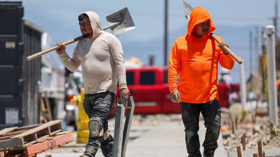 Two construction workers on the job