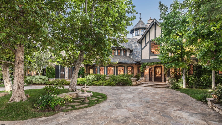 exterior of the home with a large curved driveway