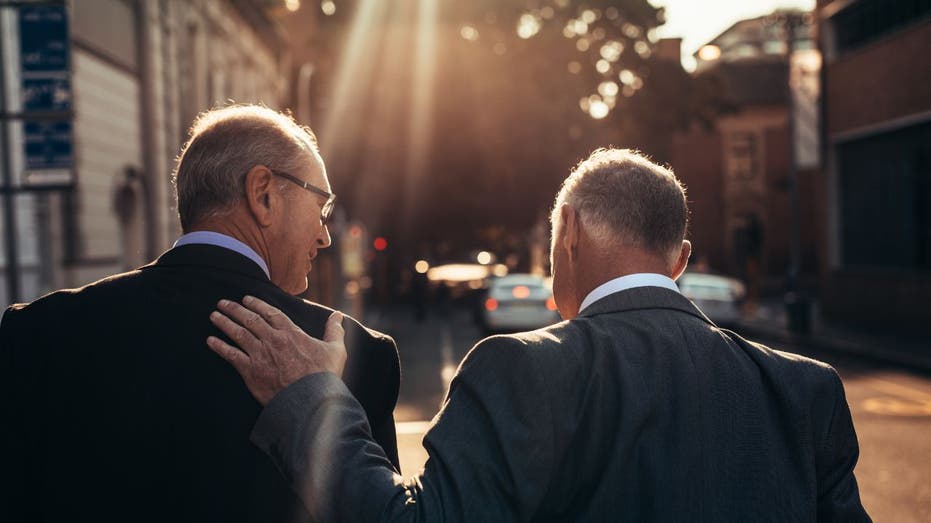 two businessmen walking away