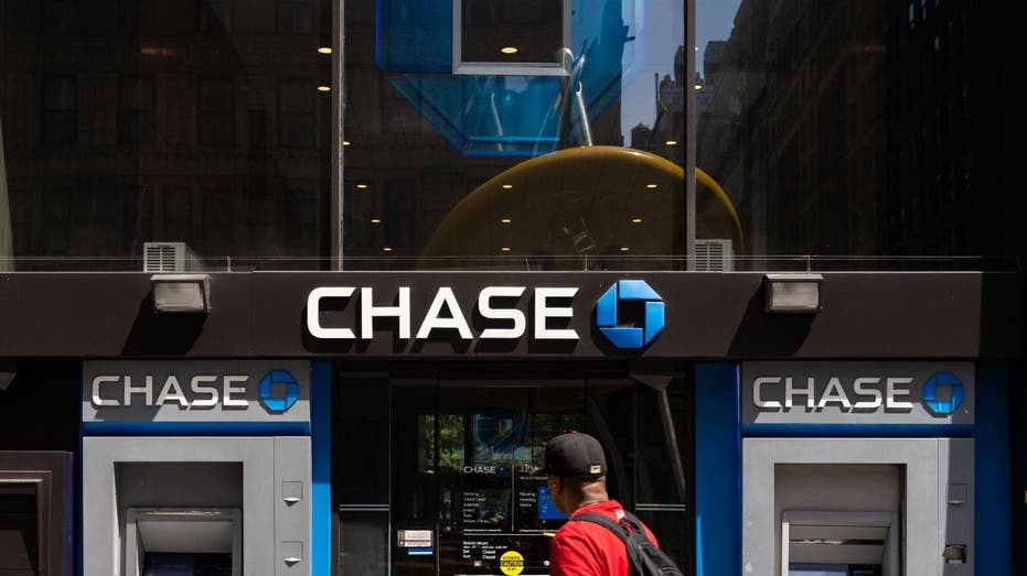 A person walks past a Chase ATM