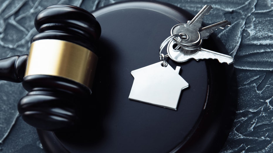 A gavel and keys to a house 