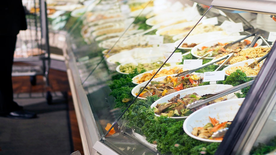 Collection of deli salads in a deli display.