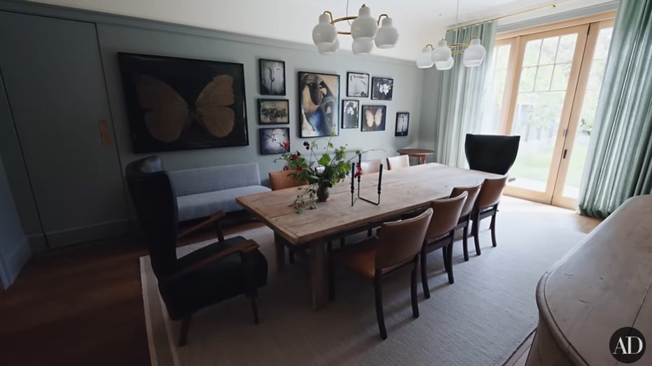 The dining room features photography by Garner's friend, as well as a wooden table large enough for 10.