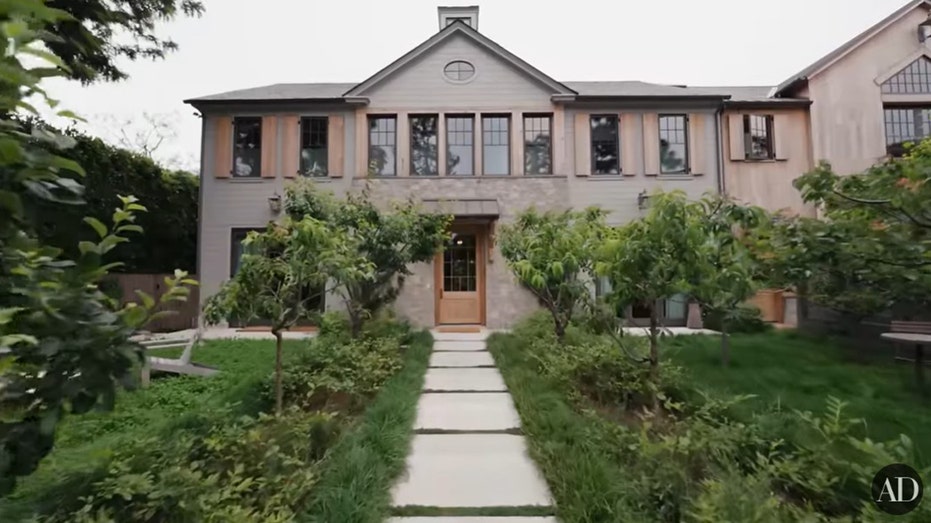 The outside of Jennifer Garner's home featuring trees and grass.