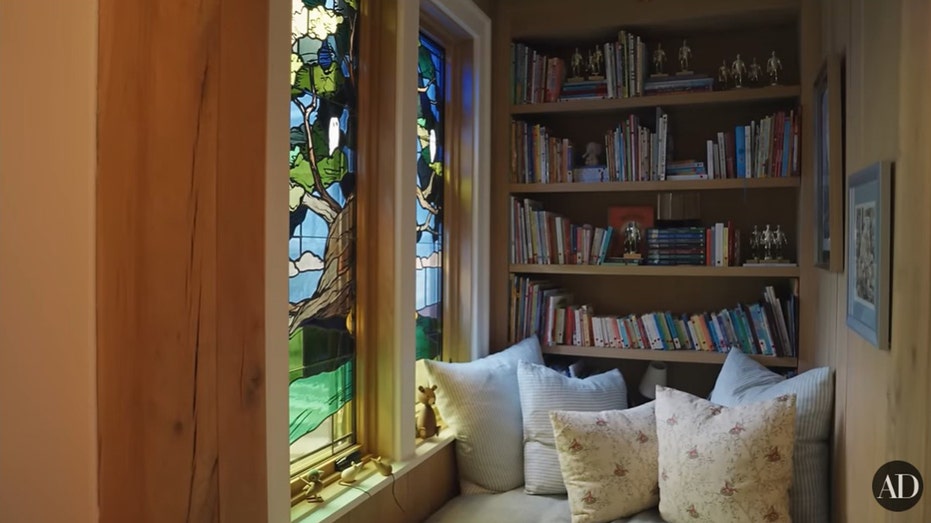 The reading nook features a stained glass window design.