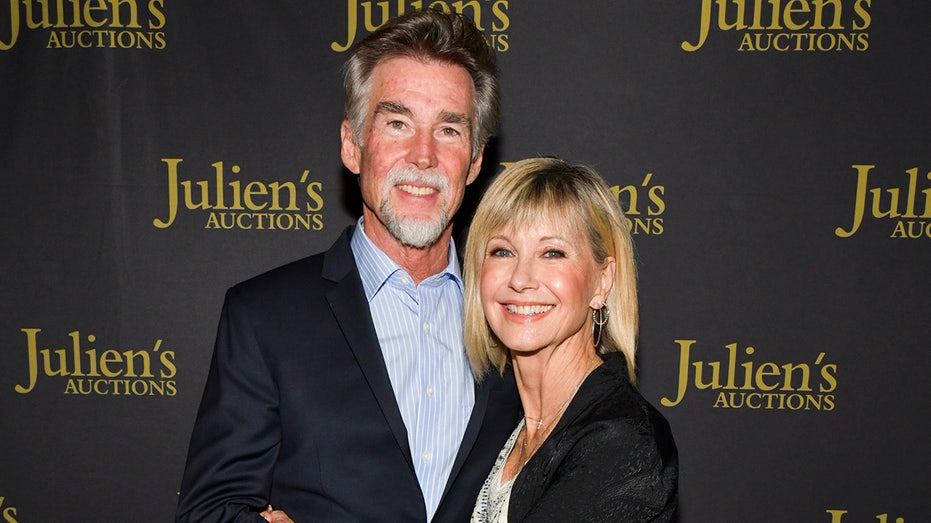 Olivia Newton-John and John Easterling on the red carpet at a Julien's Auctions event.