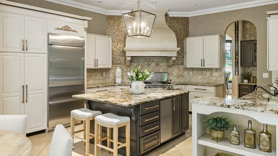 The kitchen features an eat-in center island as well as a less formal dining area.