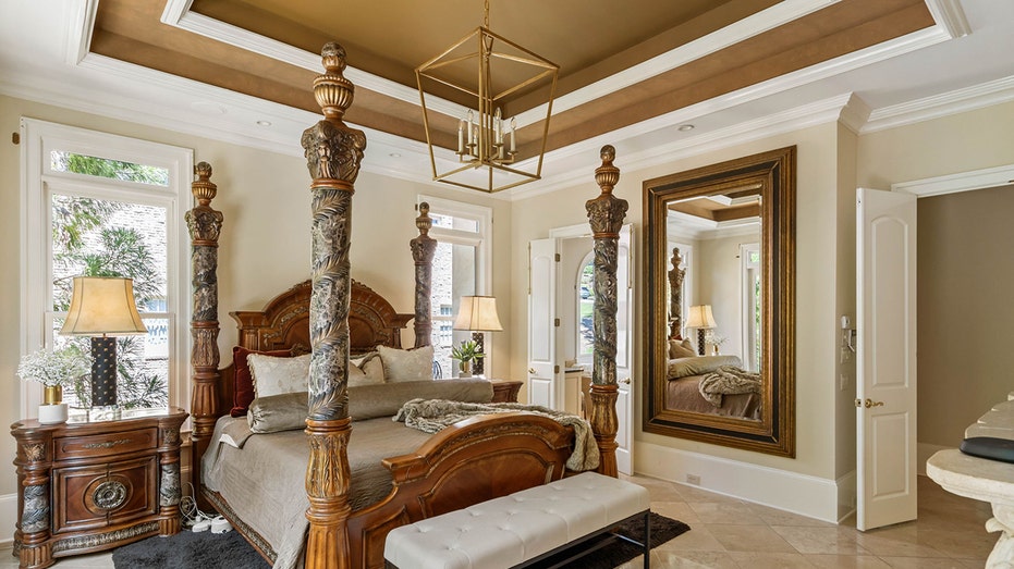 The primary bedroom features a trey ceiling and marble floors.