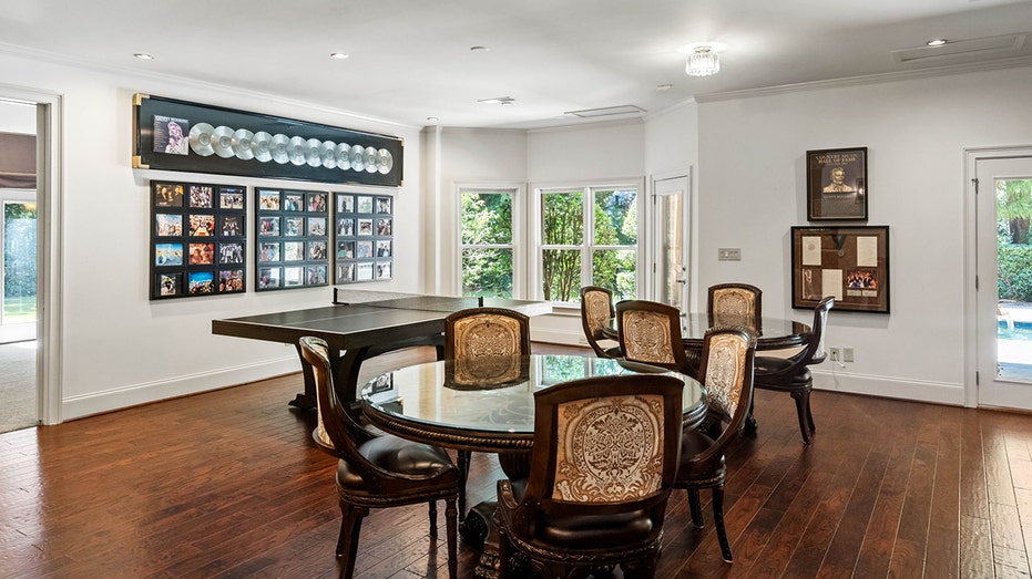 The game room features poker tabled, a ping pong table and many of Rogers' platinum records on the walls.