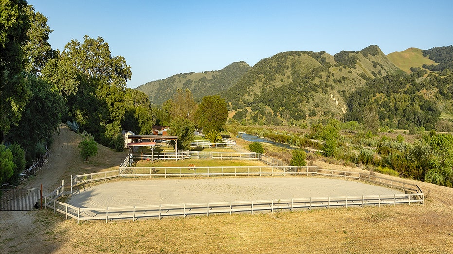 The home also features stables and a riding area.