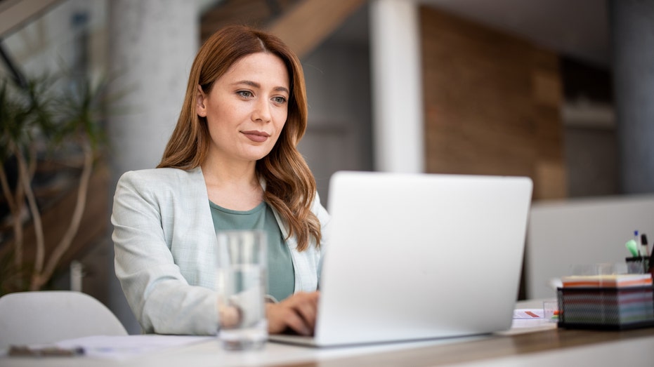 A woman typing on her computer