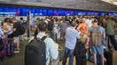 ORLANDO, FLORIDA - JULY 19: Passengers wait on long queues at check-in counters due to the global communications outage caused by CrowdStrike at Orlando International Airport on July 19, 2024, in Orlando, Florida. Businesses and airlines worldwide continue to be affected by a global technology outage attributed to a software update administered by CrowdStrike, a cybersecurity firm whose software is used by various industries around the world. 