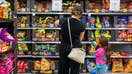 A family shops for Halloween candy at a Walmart Supercenter on October 16, 2024 in Austin, Texas. Due in part to a shortage of cocoa beans, Halloween candy prices are on the rise this year as chocolate prices have climbed 7.5%. Candy companies have begun shifting to non-chocolate candies as chocolate makers deal with shrinking margins and a decrease in sales.