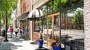 Monroe, Georgia, Row of small local businesses with pedestrians walking on sidewalk. 